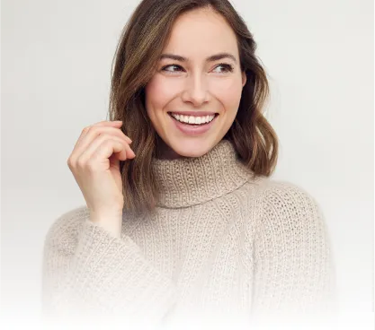 A woman in a sweater smiling